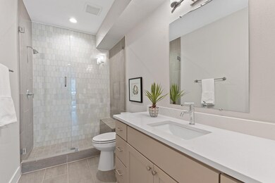 Bathroom with vanity, a stall shower, tile patterned flooring, and recessed lighting