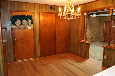 Dining area featuring wood walls, a textured ceili
