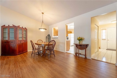 Dining room with light wood-style floors and baseboards