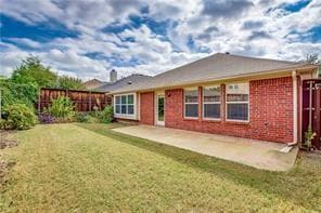 Back of house featuring a yard and a patio
