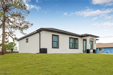 Rear view of property featuring stucco siding and