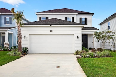 View of front of property with roof with shingles, driveway, a front yard, and an attached garage