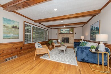 Living room with a fireplace, light hardwood / woo