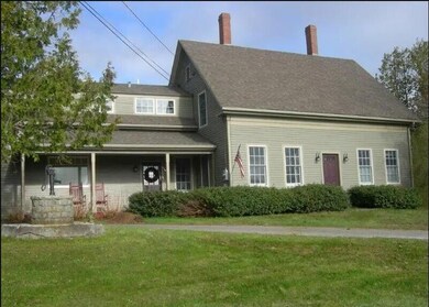 Front with porch in ell.