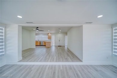 Empty room featuring a ceiling fan, light wood-typ