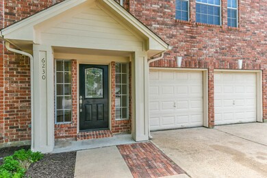 Welcoming black front door with side windows, and