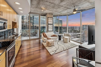 Living area featuring floor to ceiling windows, d