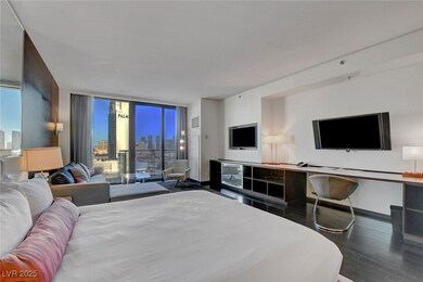 Bedroom with wood finished floors, expansive windo