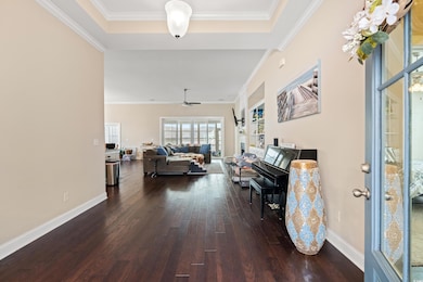 Living area featuring crown molding, baseboards, a