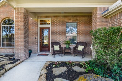 Enjoy a cup of coffee in the morning on this charming front porch.  Front door freshly stained.