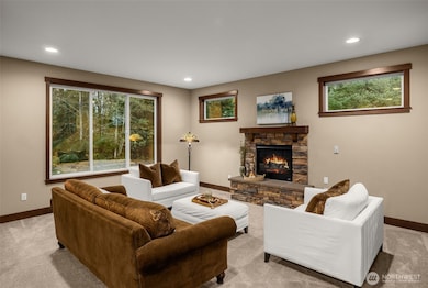 Your light and bright living room is surrounded by windows and a cozy gas fireplace.