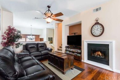 Open Family Room With Cozy Fireplace with Framed S