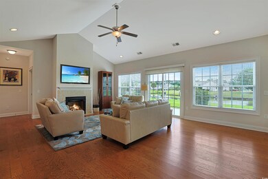 Living room with high vaulted ceiling, a fireplace