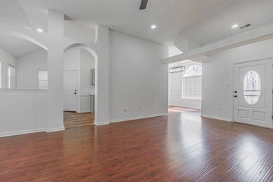 Foyer entrance featuring ceiling fan, lofted ceili