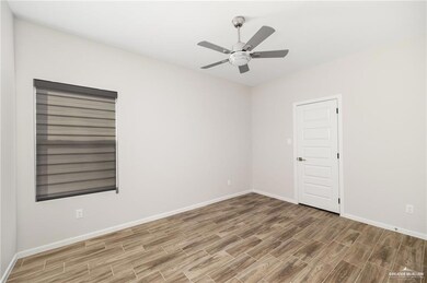 Unfurnished room featuring baseboards, a ceiling fan, and wood finish floors