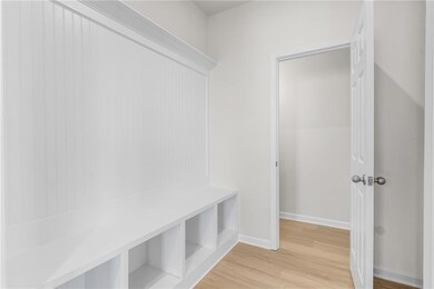 Mudroom with light hardwood / wood-style flooring