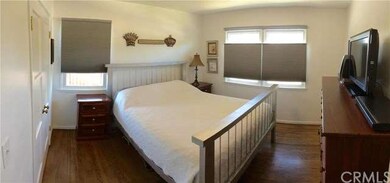 Master bedroom with original hardwood flooring, cu