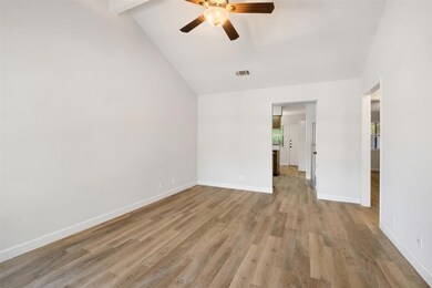 Unfurnished room featuring ceiling fan, light woo