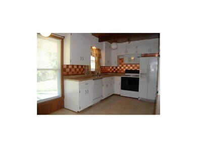 Kitchen overlooking treed back yard