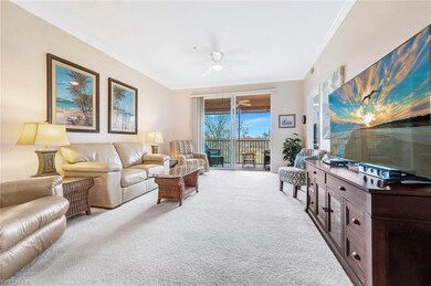 Carpeted living room with a ceiling fan and crown 