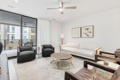 Living room with expansive windows, a ceiling fan, and recessed lighting