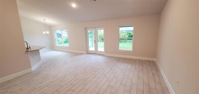 Empty room with an inviting chandelier