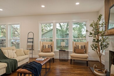 Abundant natural light pours in through large windows, enhancing the home’s spacious and airy feel.