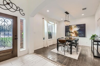 Dining area with arched walkways, baseboards, rec