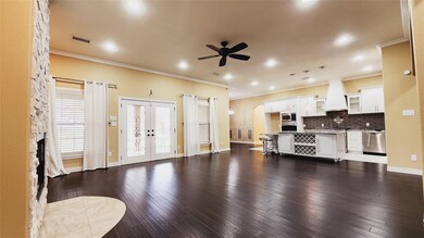 Living room featuring ornamental molding, dark woo