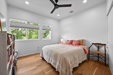 Bedroom with recessed lighting, light wood-style 