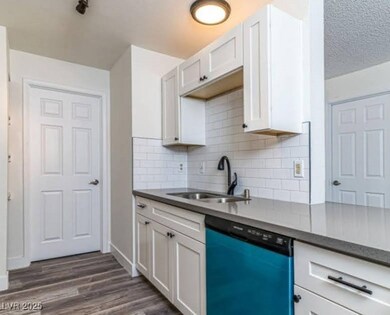 Kitchen featuring a sink, dark wood-type flooring,