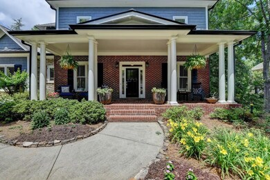 Large charming and welcoming front porch with beautiful flower garden views!