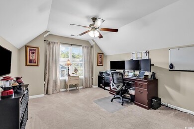 Carpeted office featuring lofted ceiling and ceili