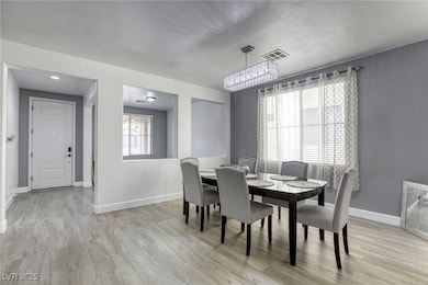 Dining room featuring a chandelier and light wood