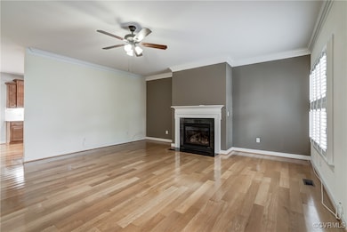 Unfurnished living room featuring a ceiling fan, a