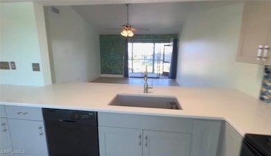 Kitchen with a sink, black appliances, open floor