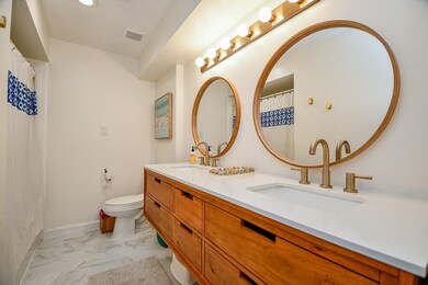 This bathroom features a modern design with dual r
