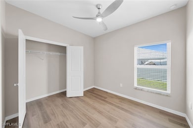 Unfurnished bedroom featuring ceiling fan, light w