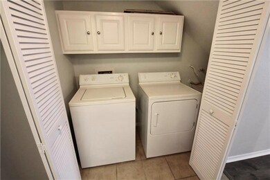 Washroom with cabinet space, washing machine and 