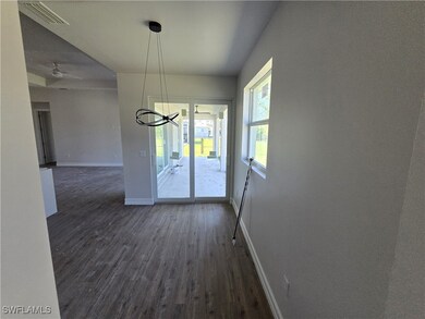 Unfurnished dining area with dark wood-style floor