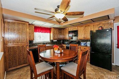 Kitchen with custom cabinetry and tile flooring.