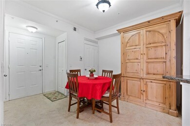 Dining room featuring ornamental molding and light tile patterned floors