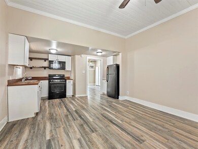 Kitchen featuring crown molding, black appliances,