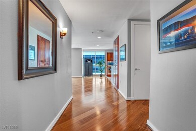 Corridor with wood finished floors and recessed lighting