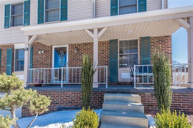 Charming front porch is surrounded by peaceful pin