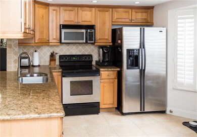 Kitchen features stainless steel appliances, hard
