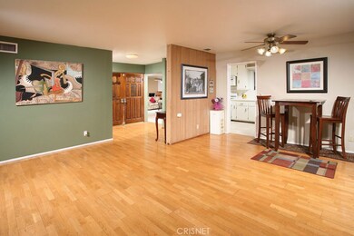 Formal dining room with designer lighted ceiling fan and gleaming hardwood floors.