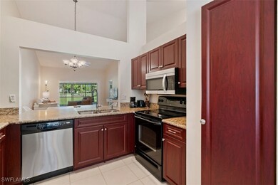 Kitchen with a chandelier, light stone counters, a