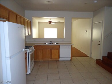Kitchen featuring white appliances, light tile pat