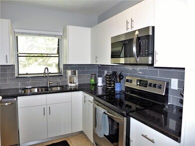 Modern kitchen features snack counter, lots of cab